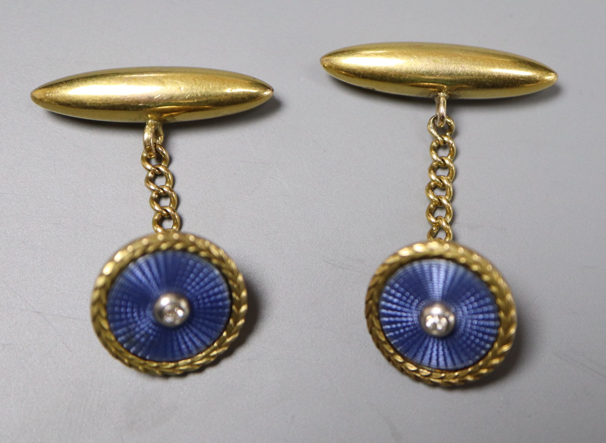 A pair of early-mid 20th century French? yellow metal, guilloche enamel and diamond set circular cufflinks,